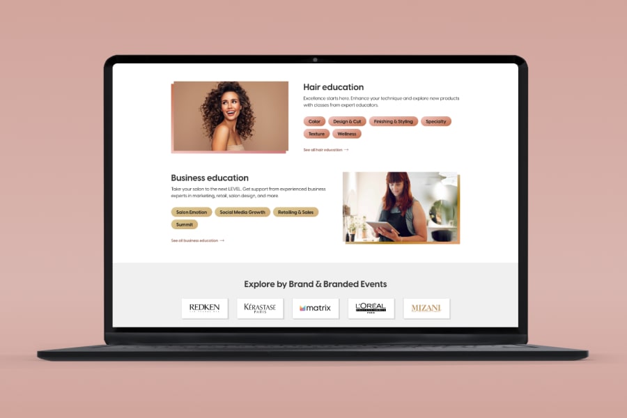 A laptop is opened to a web page scrolling through modules about hair education, business education, and brands.