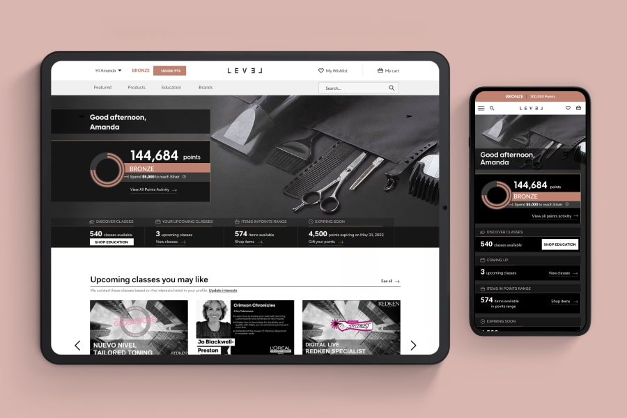 A tablet and smartphone lay open next to each other on a pink background, both displaying the points summary page on different platforms.