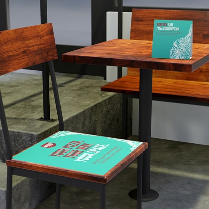 A 3-D rendered chair and table at a MOD location showcase how a branded table tent and seat covering could look.