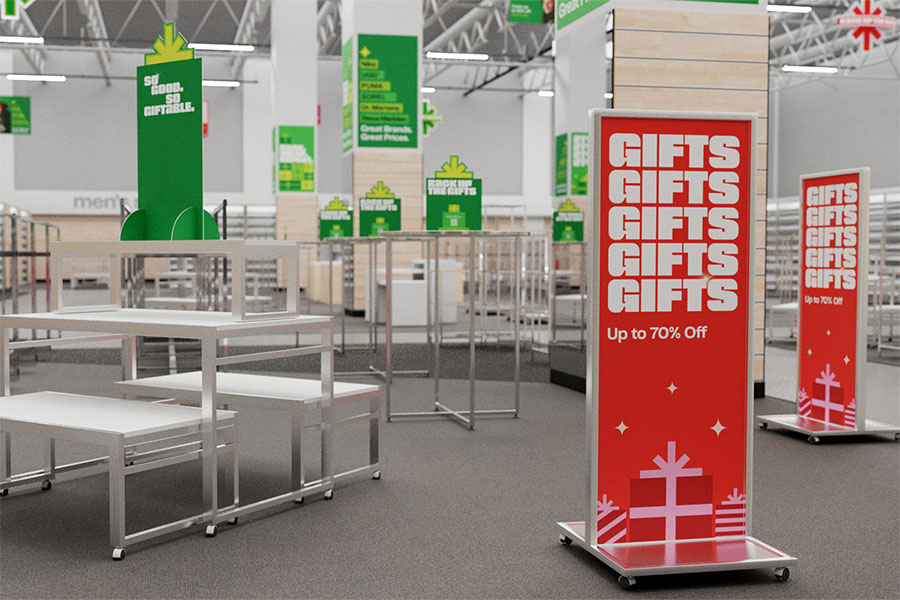 A Nordstrom Rack has been stripped of merchandise, leaving tables and racks dotted with tabletop signage, wraps, and freestanding signs.